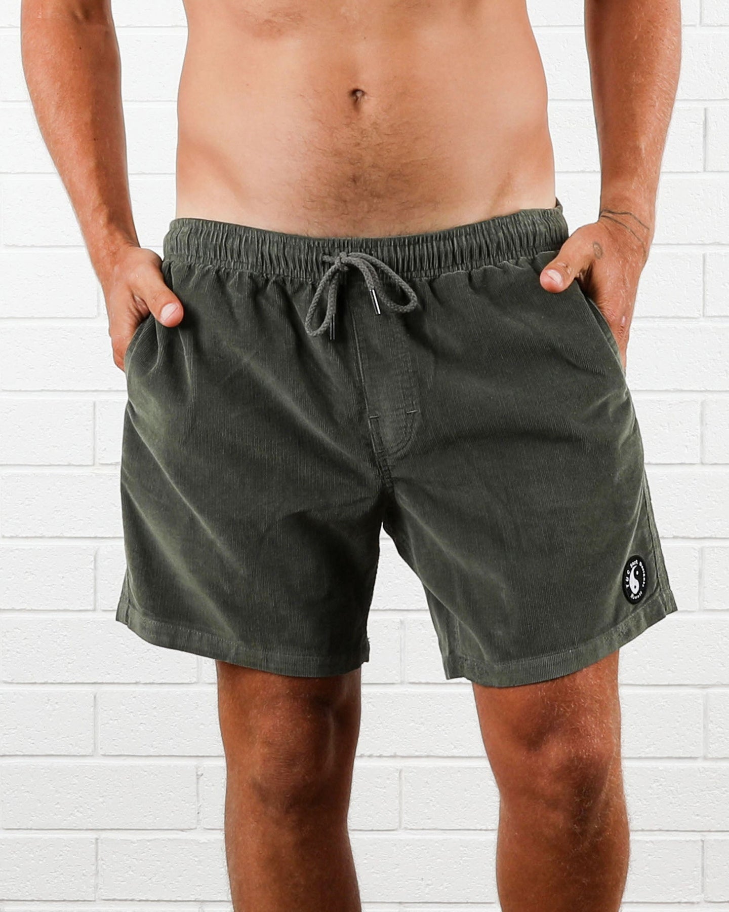 Olive green cord shorts with elastic waist and drawstring tie