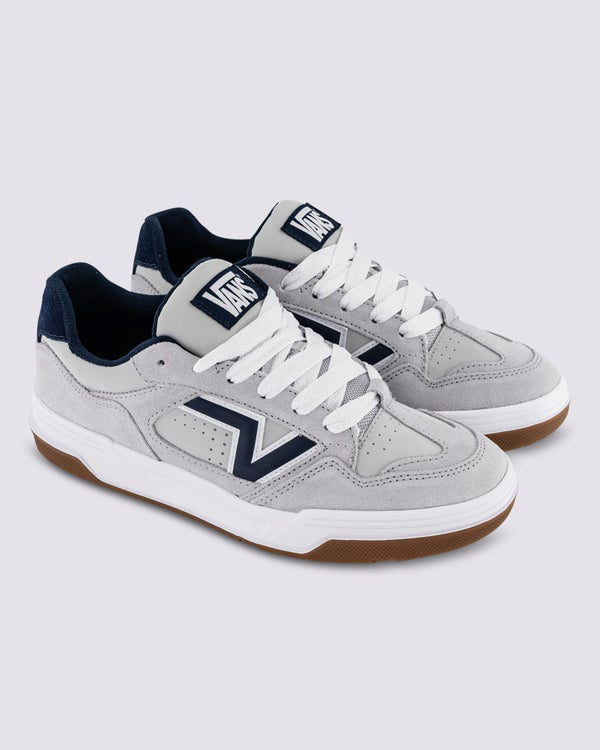 Vans grey suede skate shoes with white laces, gum sole, and navy accents, designed for style and performance.
