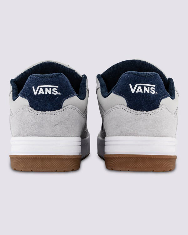 Back view of Vans grey and navy skate shoes with white logo on heel and gum rubber outsole.