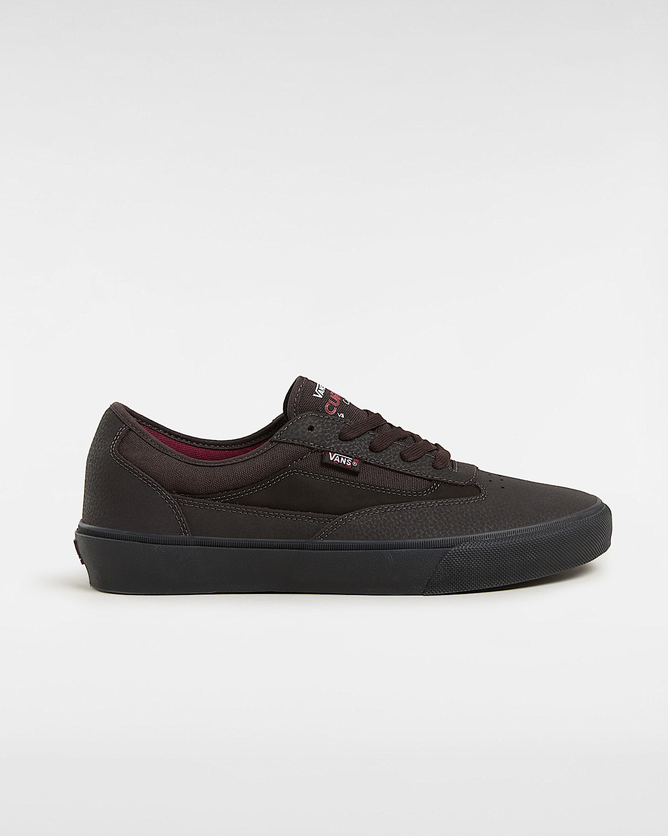 Vans brown low-top skate shoe with black sole, burgundy lining and side stripe branding.