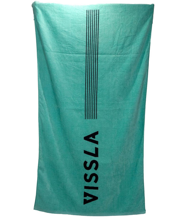 Turquoise Vissla beach towel with black vertical stripe design and bold logo text, displayed against a plain background.