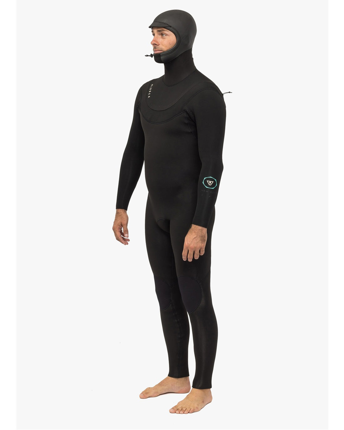 Man wearing a black full-body wetsuit with an integrated hood, shown in a side profile, standing barefoot.
