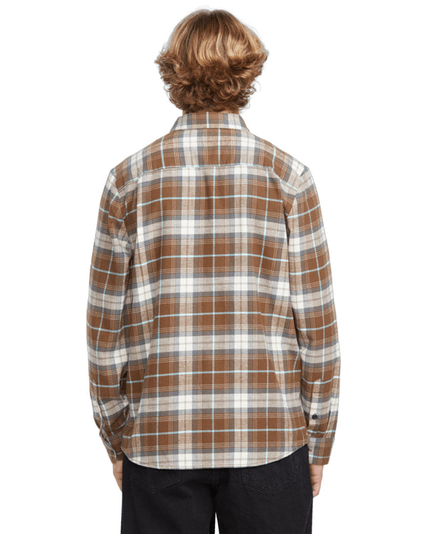 Back view of a male model wearing a brown and white plaid button-up shirt with long sleeves, paired with black pants.