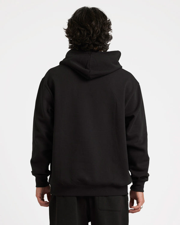 Back view of a model wearing a black Volcom hoodie with a relaxed fit, hood up, and ribbed cuffs and hem.