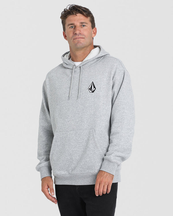 Male model wearing a light grey Volcom hoodie with a small black logo on the chest, front pocket, and drawstring hood.