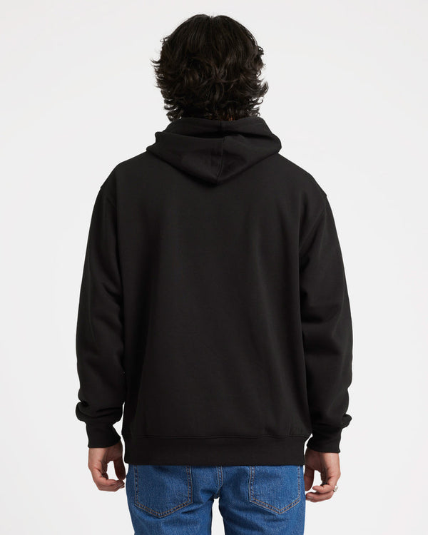 Back view of a model wearing a black Volcom hoodie with a relaxed fit, hood down, and ribbed cuffs, paired with blue jeans