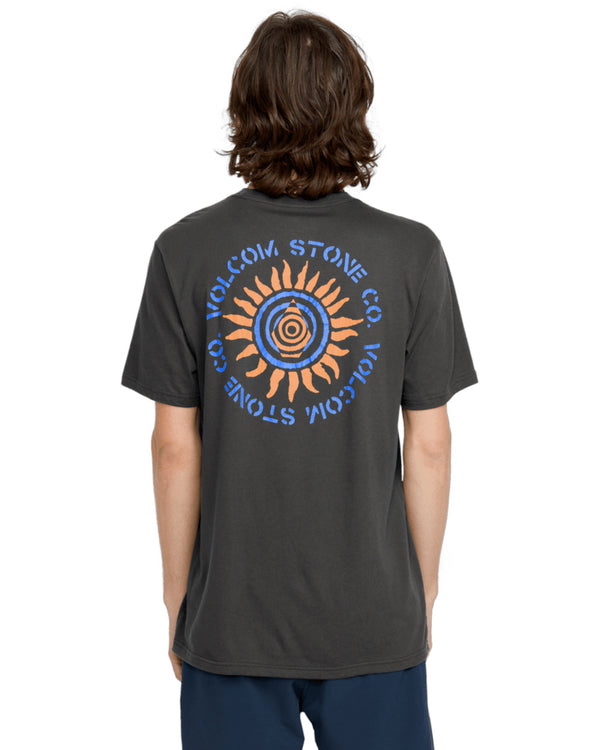 Male model wearing a black T-shirt with a large sun-inspired graphic in orange and blue on the back, featuring 'Volcom Stone Co.