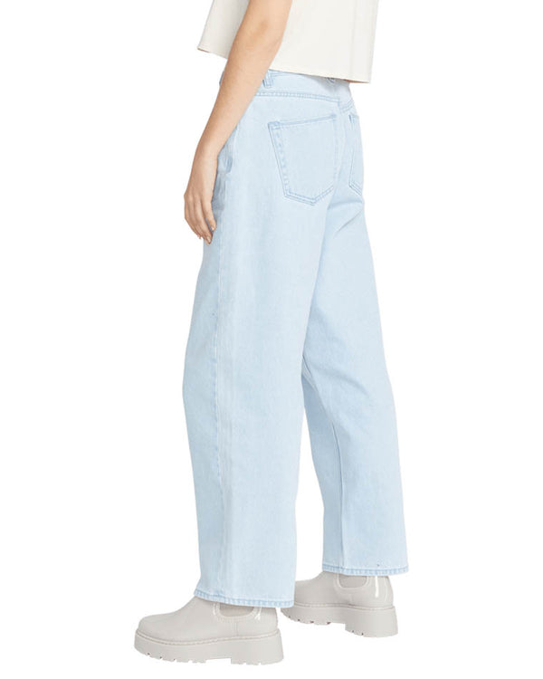 Side view of high-waisted light blue straight-leg jeans with back pockets, paired with a graphic tee and chunky gray ankle boots.