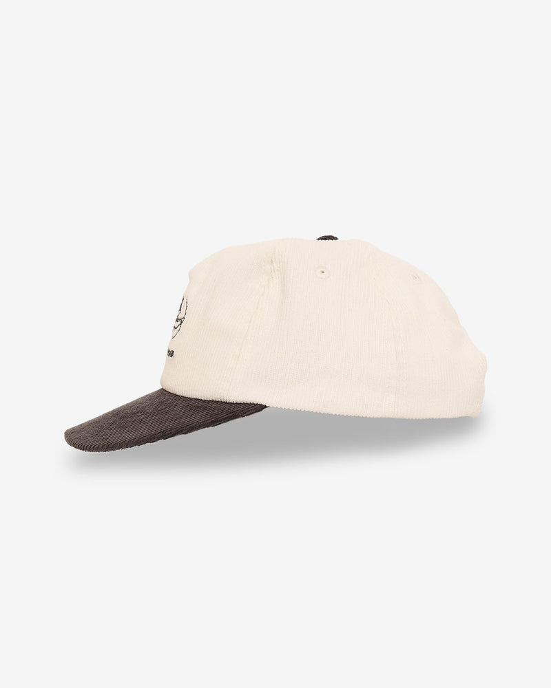 Side view of a two-tone corduroy cap with a cream-colored crown and brown brim, featuring subtle embroidered details.