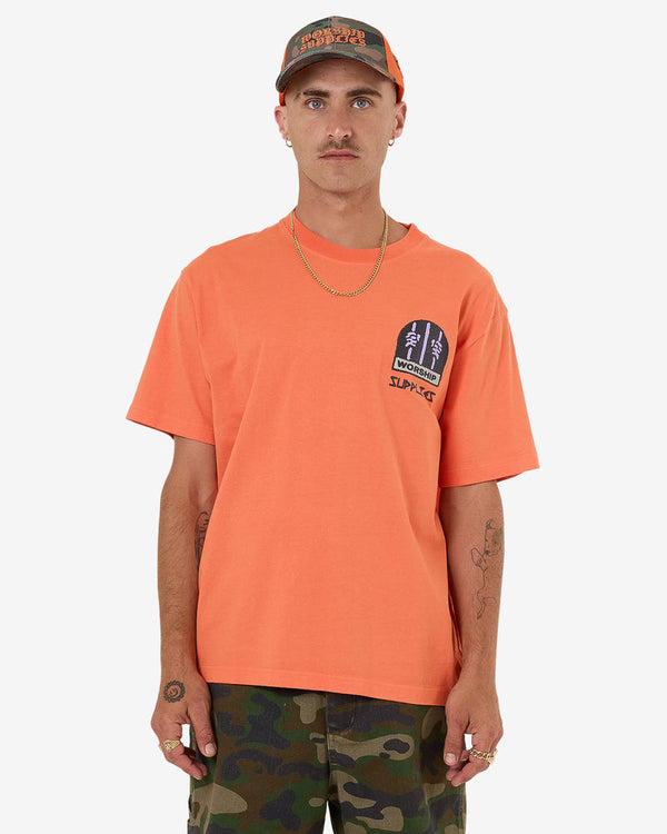 Orange graphic tee with front chest print and relaxed fit