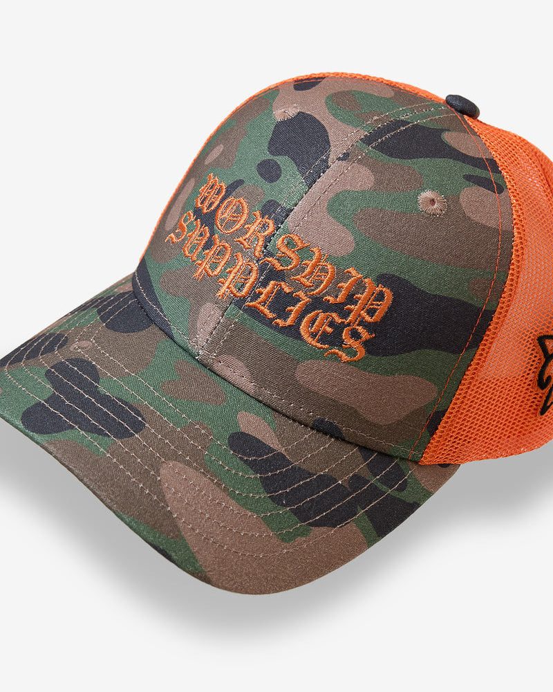 Angled view of camo trucker cap with bold orange embroidery
