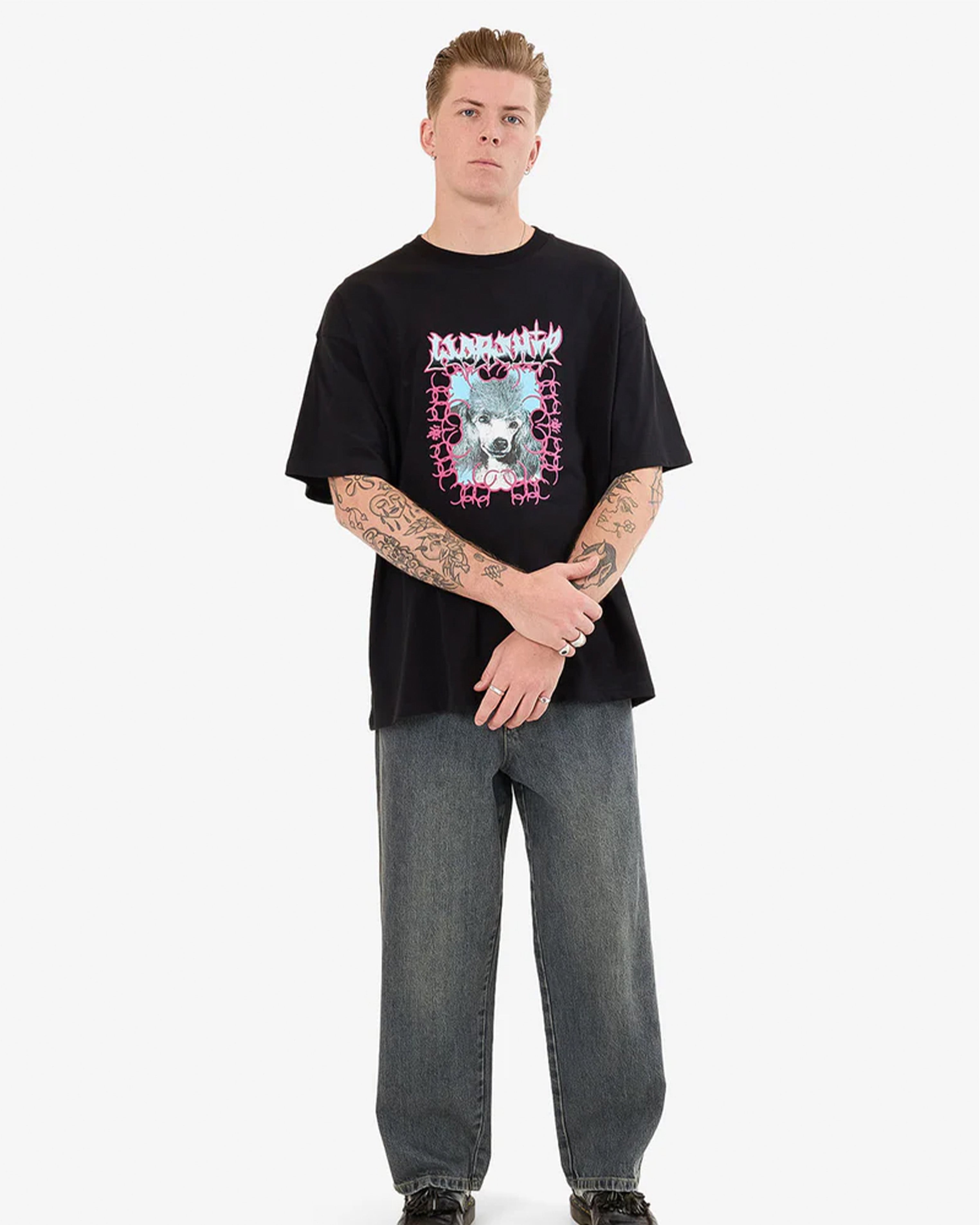 Full outfit with black graphic tee and loose-fit washed jeans on male model