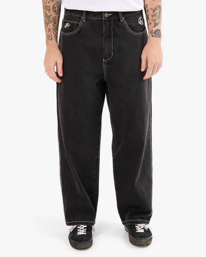 Front view of men's black wide-leg jeans with contrast white stitching.