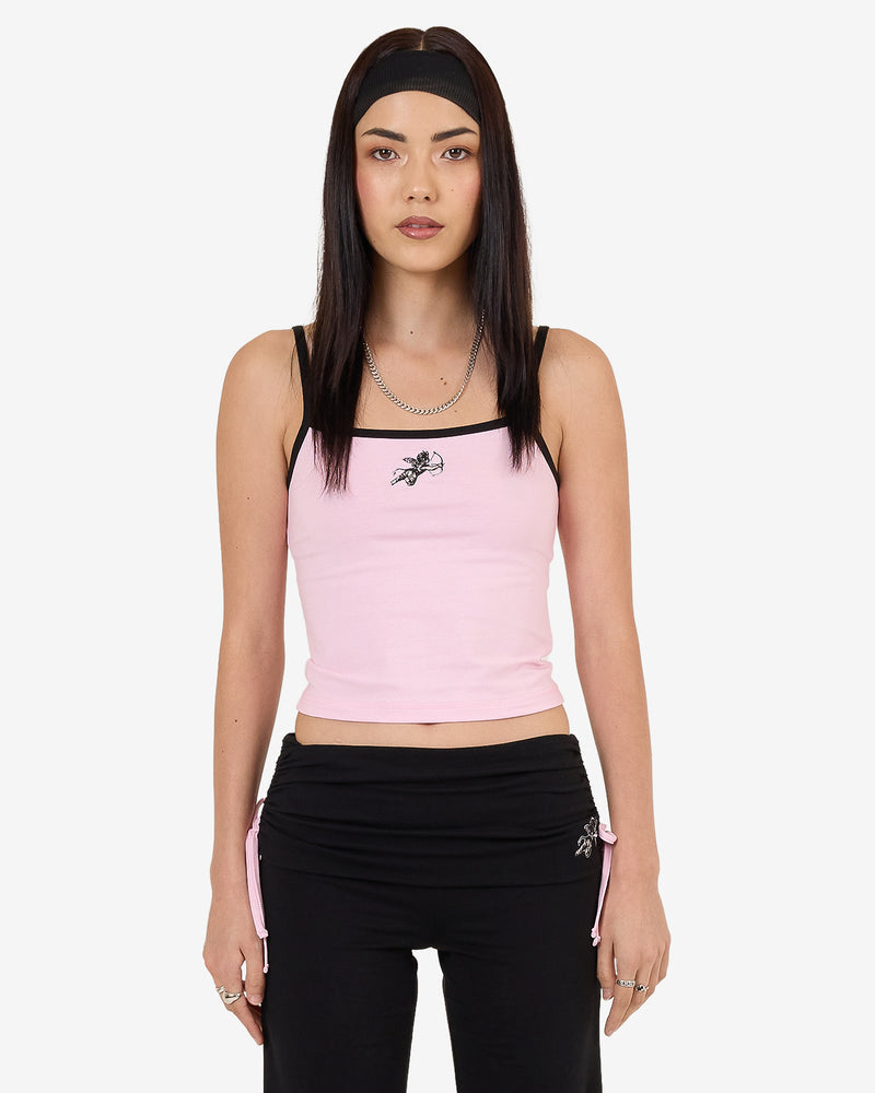 Pink cropped tank top with black straps and "Worship" logo, paired with black drawstring pants with embroidered design.