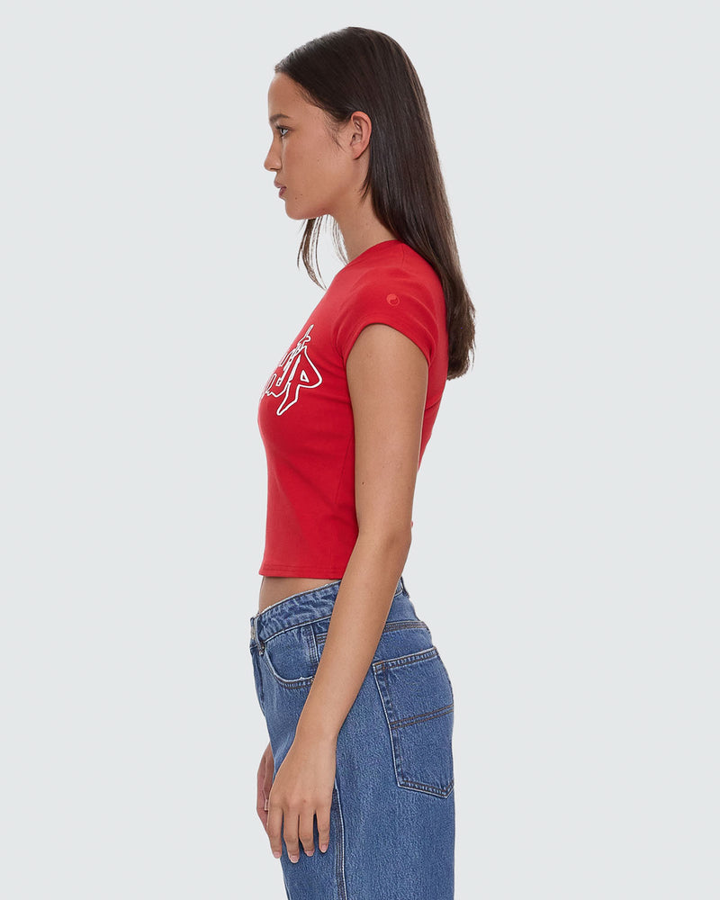 Side view of red cropped t-shirt with white "Worship" graphic design, paired with denim jeans.