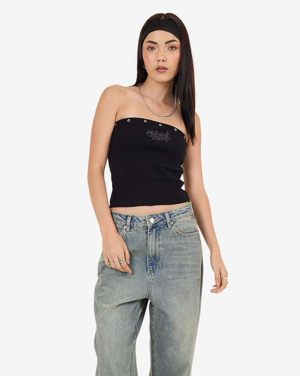 Black strapless graphic tube top styled with relaxed fit blue jeans