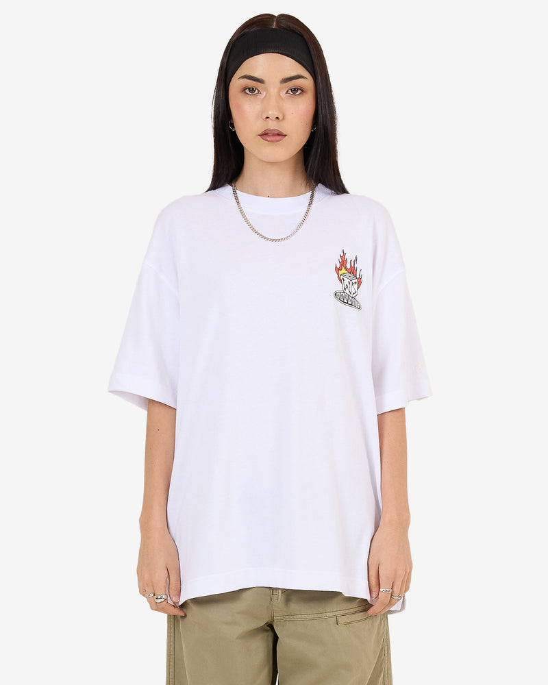White oversized tee with small flaming dice Worship graphic on chest and khaki pants