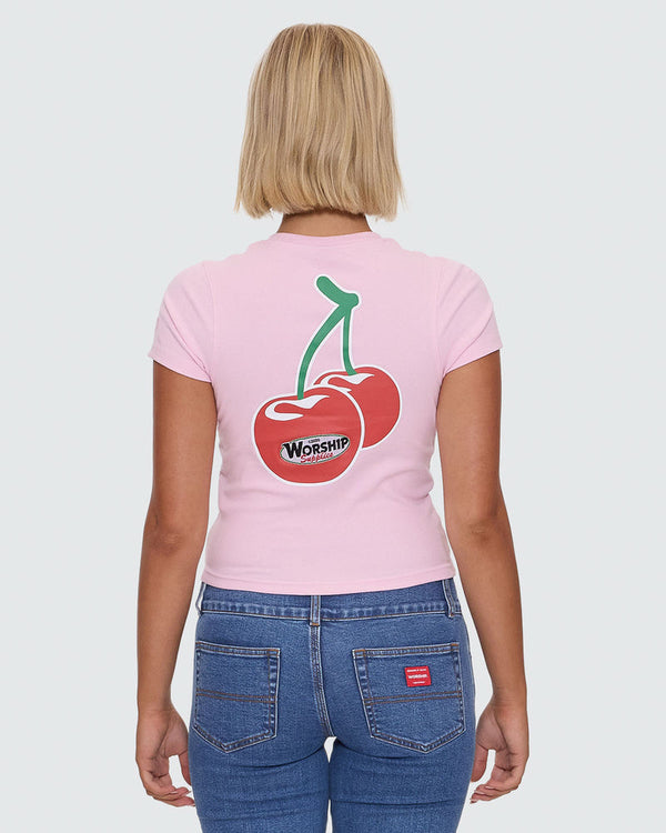 Light pink crop tee with large cherry Worship graphic on back and blue jeans