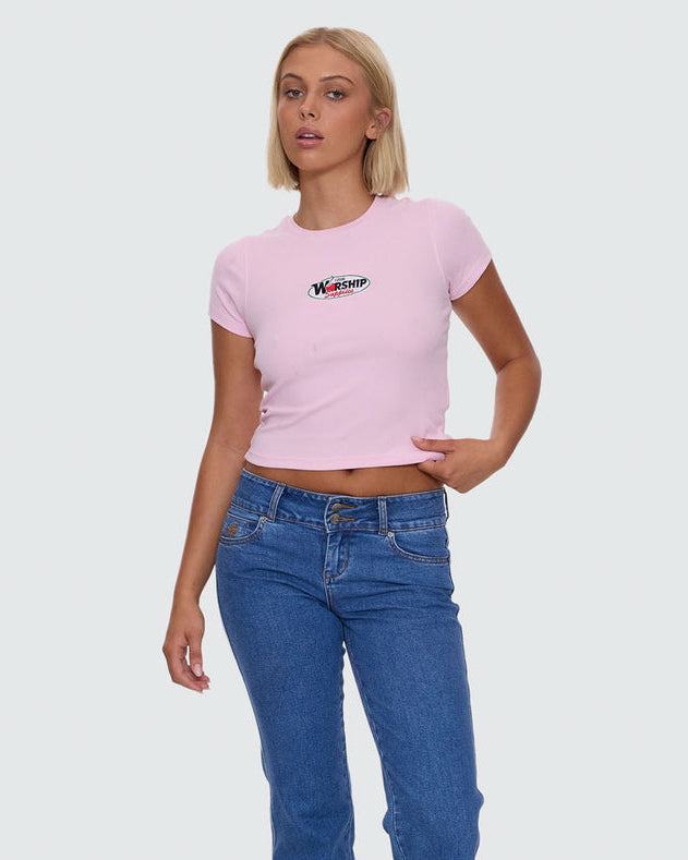 Light pink Worship graphic crop tee styled with blue high waisted jeans