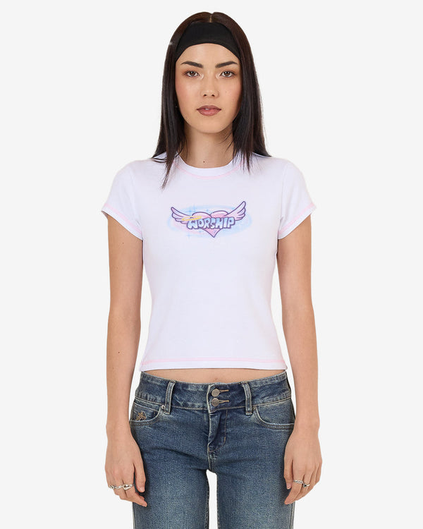 White fitted crop tee with pastel pink trim and Worship winged heart graphic on chest