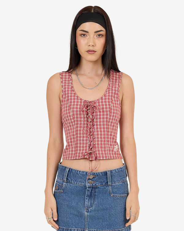 Front view of red check sleeveless lace-up top with scoop neck and cropped fit