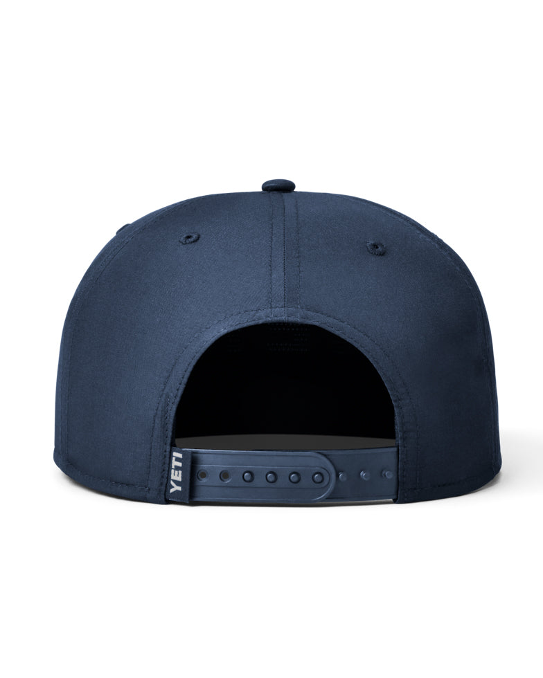 Back view of a dark blue YETI cap featuring an adjustable snapback with the YETI woven label on the side.