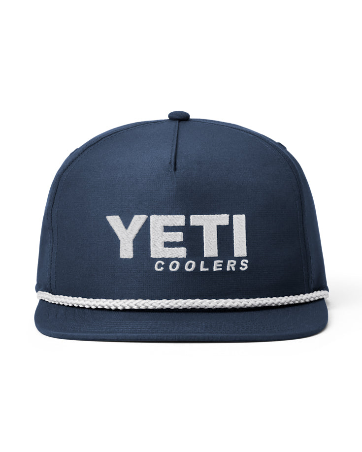 Front view of a navy YETI snapback cap featuring bold white 'YETI COOLERS' embroidery and a white rope detail.