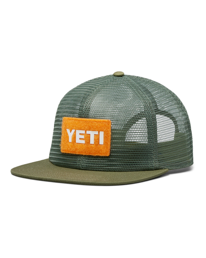 YETI cap in olive green with an orange patch logo on the front, breathable mesh back panels, and a flat brim design.