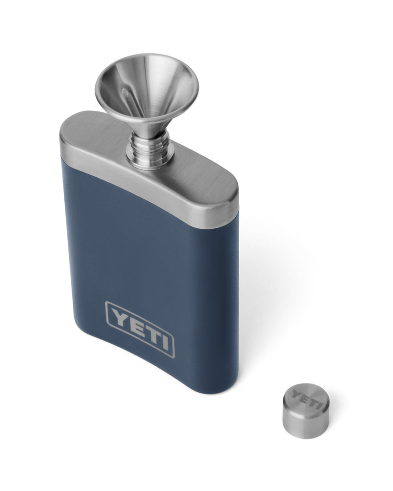 YETI navy blue stainless steel flask with an open top, metal funnel, and removed cap, designed for easy pouring.