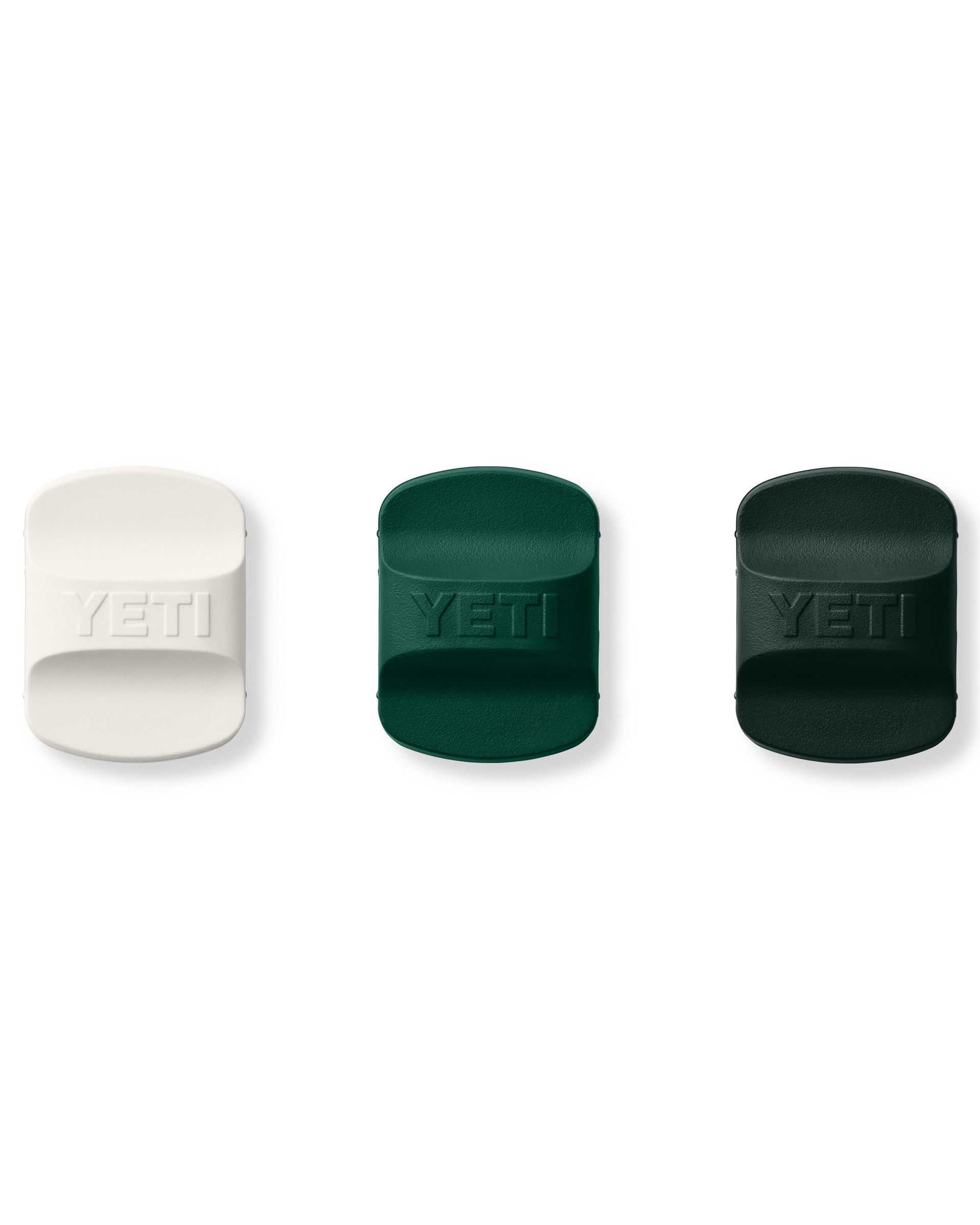 Three YETI MagSlider lid sliders in white, green, and dark green.