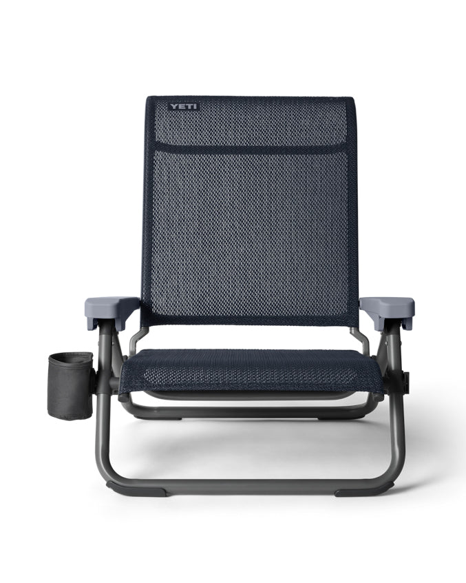 Yeti low beach chair in navy with cup holder and sturdy frame.